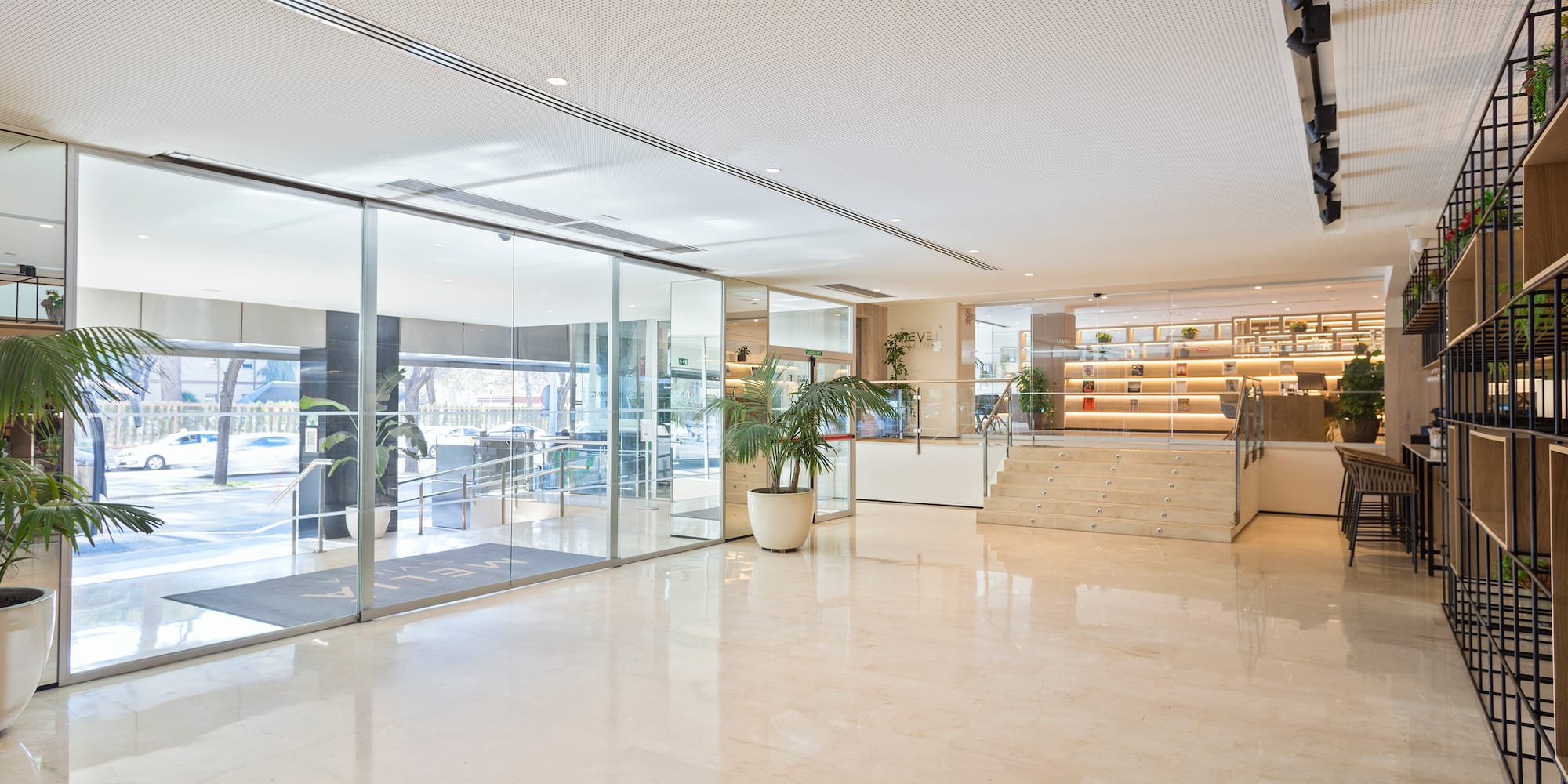 a large room with glass doors and stairs
