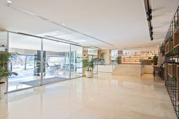 a large room with glass doors and stairs