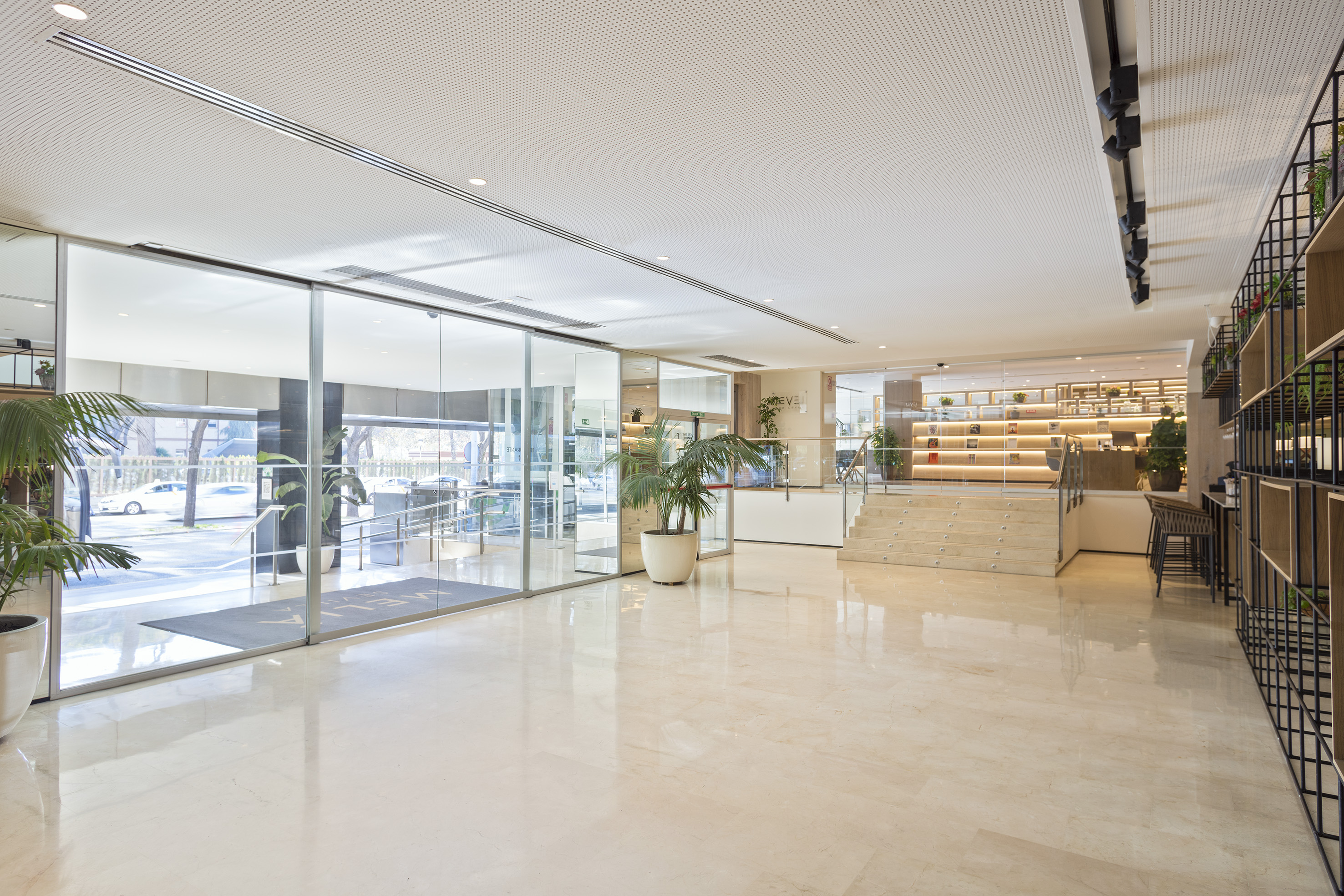 a large room with glass doors and stairs