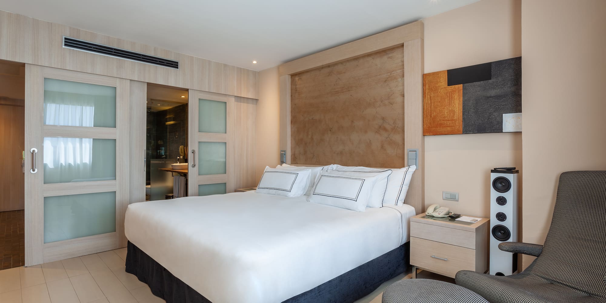 a bedroom with a bed and a speaker