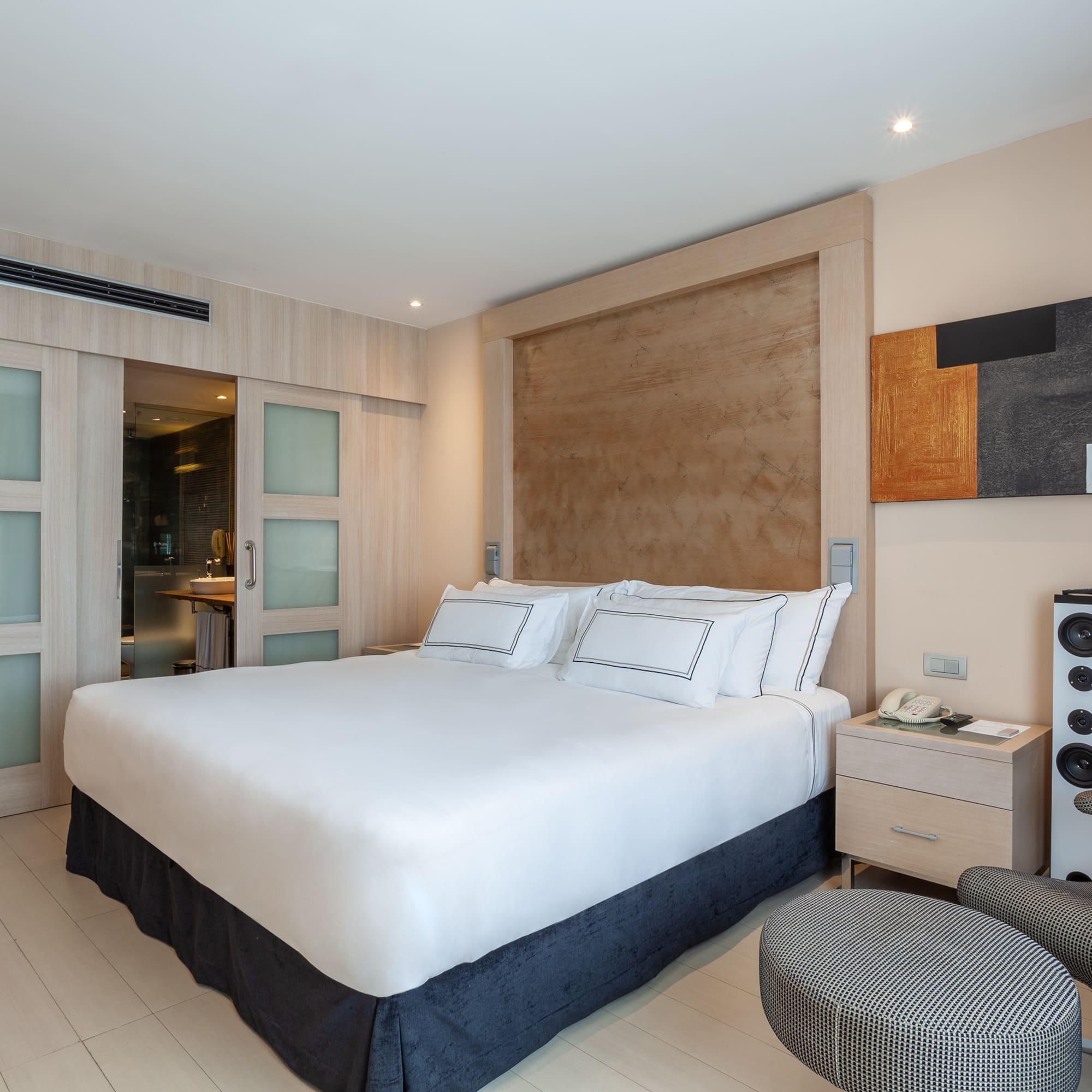 a bedroom with a bed and a speaker