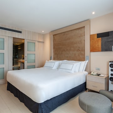 a bedroom with a bed and a speaker