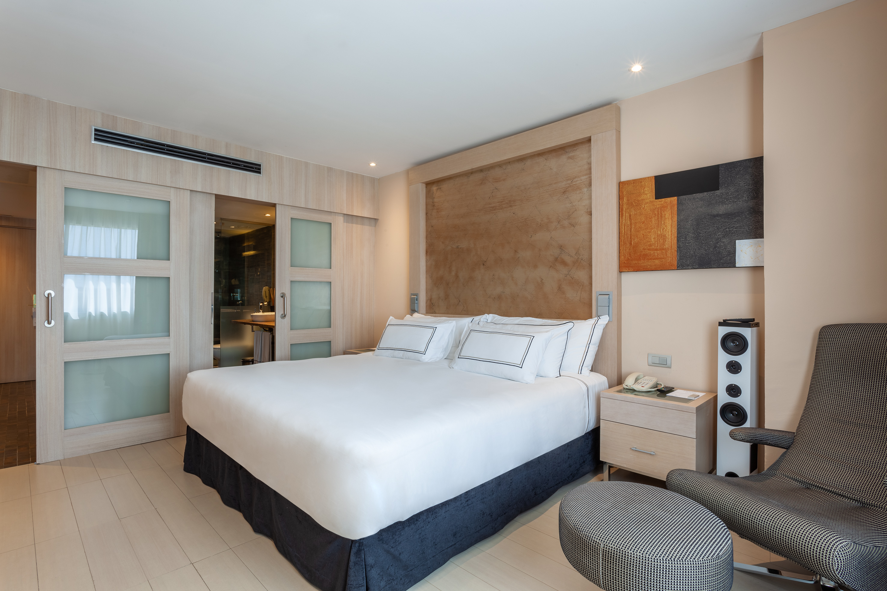 a bedroom with a bed and a speaker