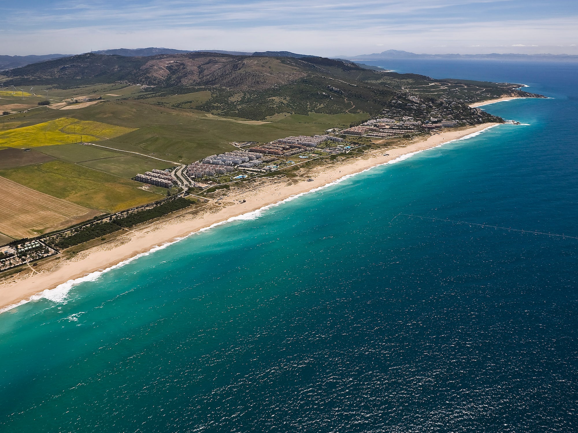 a beach with land and water