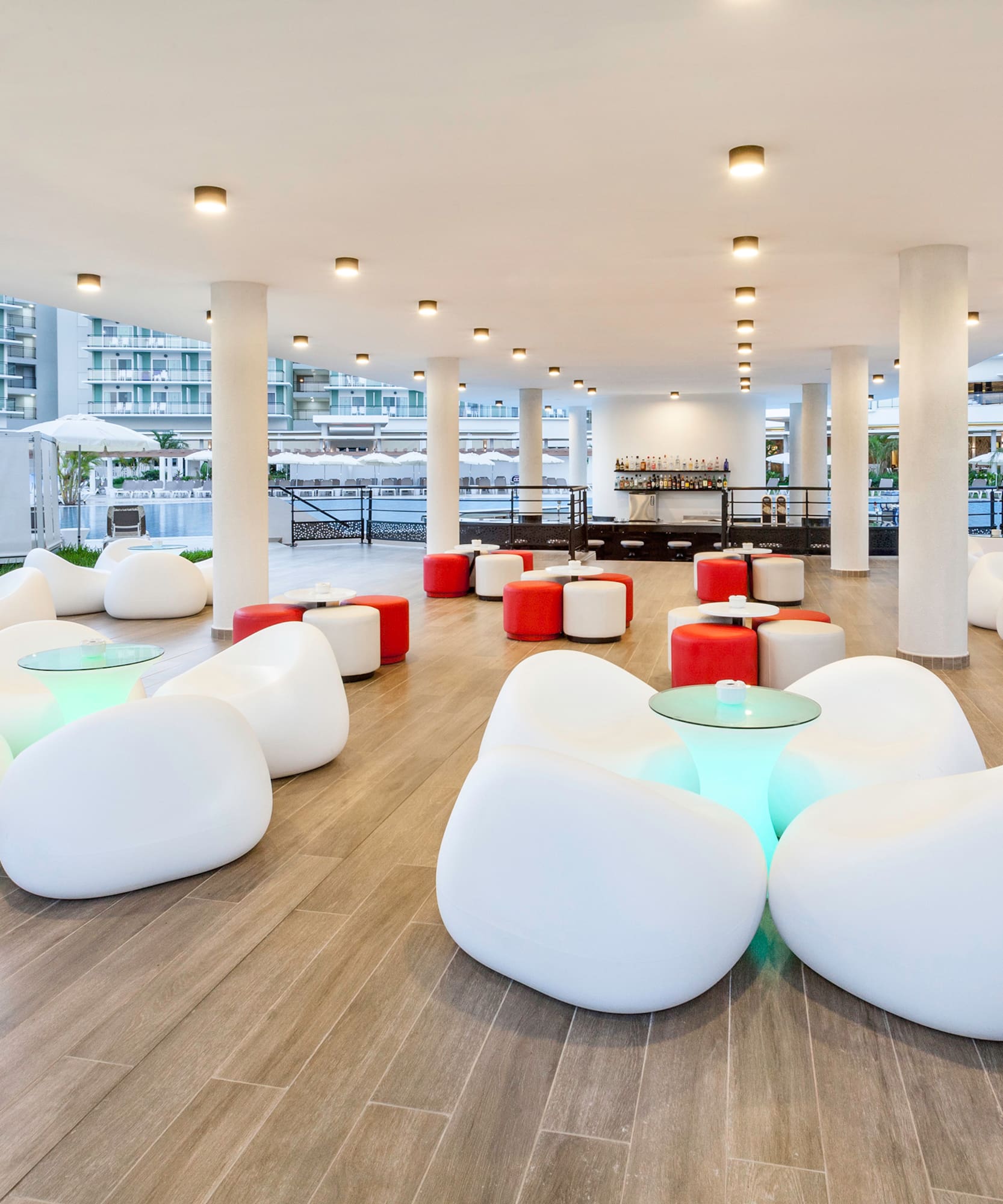 a room with white chairs and tables