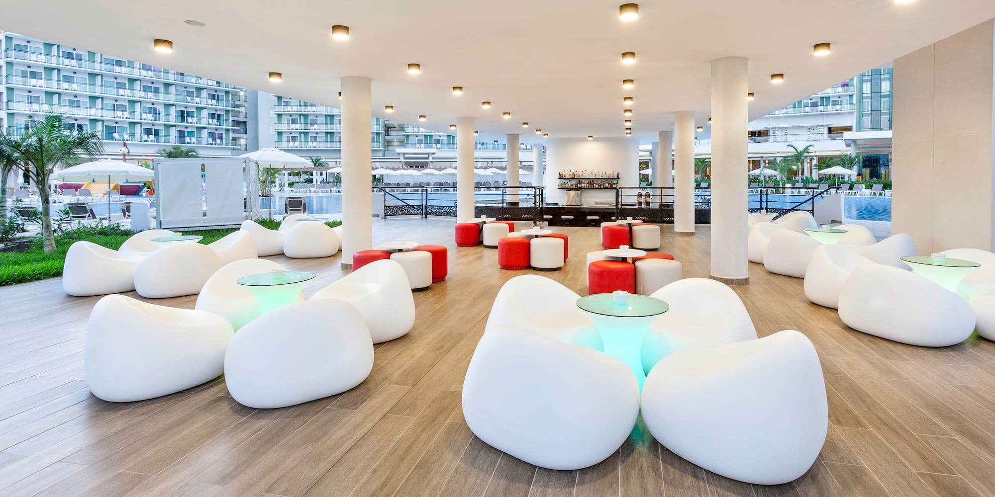 a room with white chairs and tables