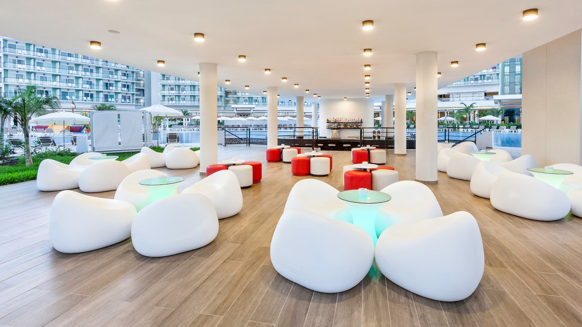 a room with white chairs and tables