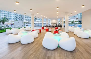 a room with white chairs and tables