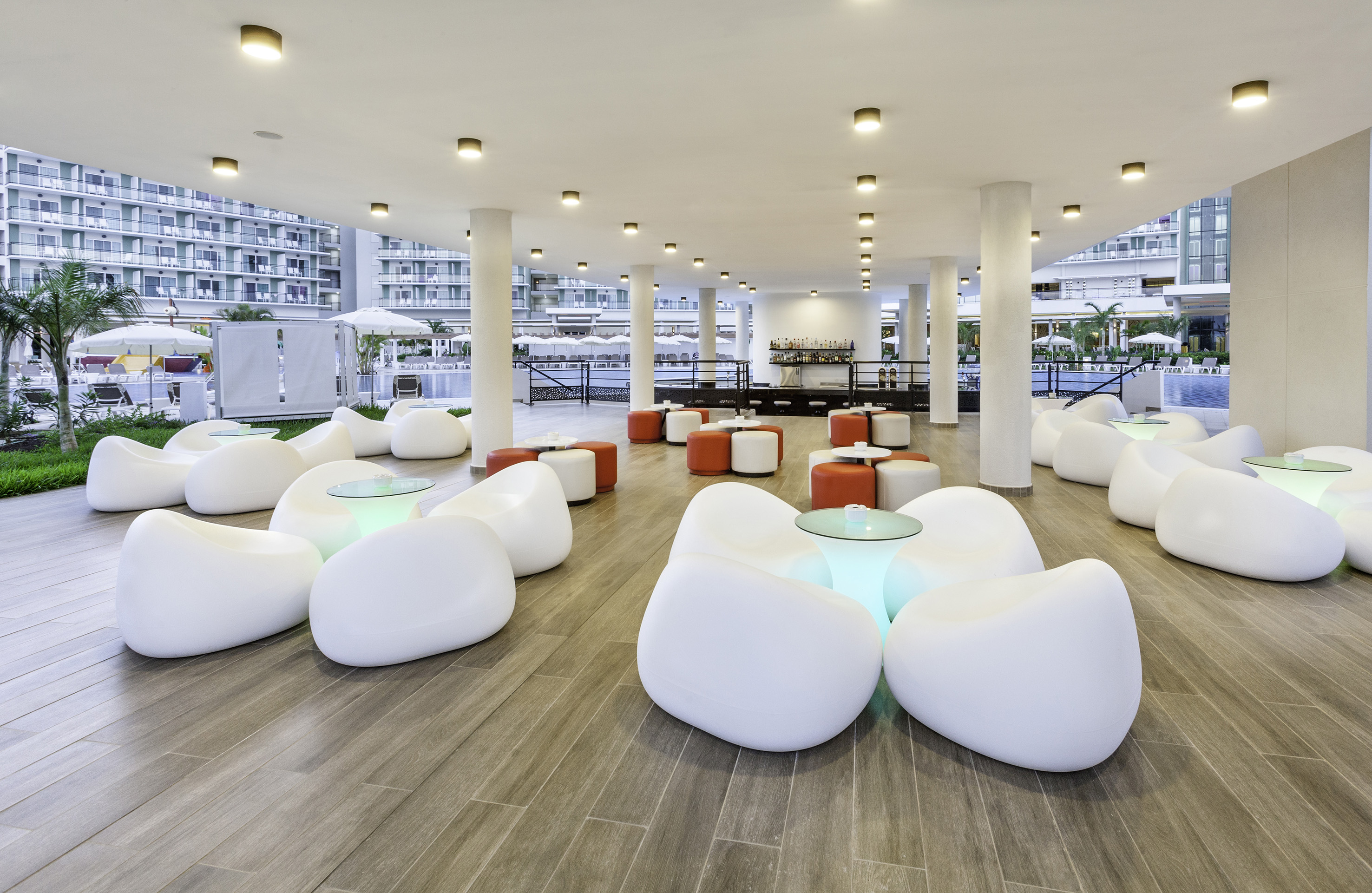 a room with white chairs and tables