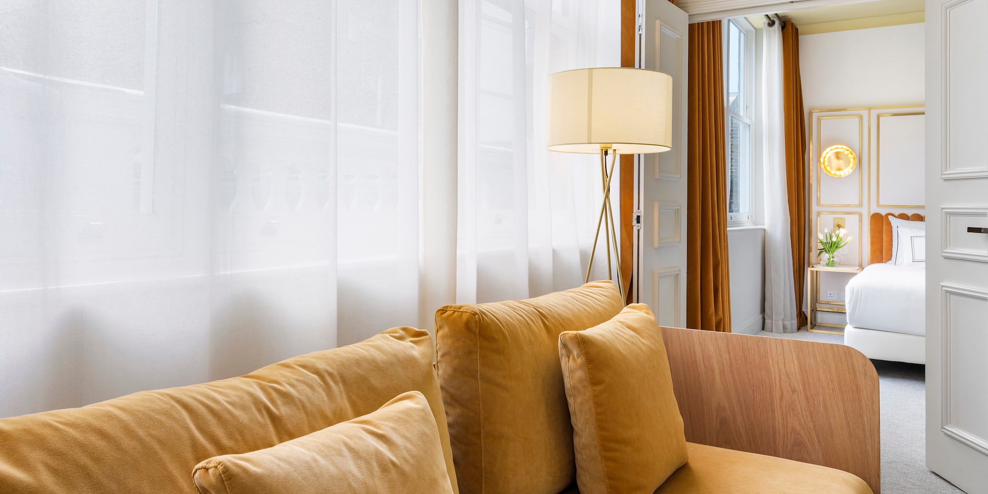 a couch with pillows and a lamp in a room