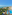 Sprawling beachfront resort with pools, large hotel buildings, and clear blue sea.