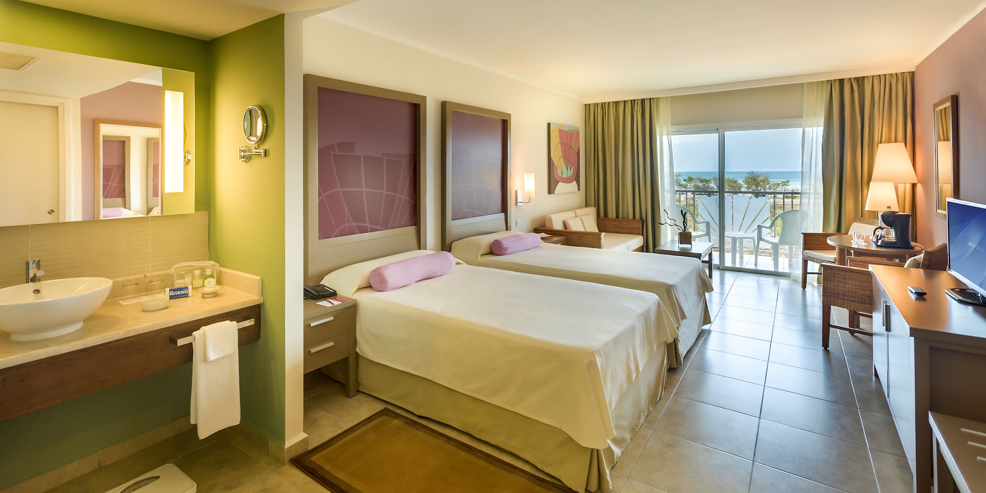 a room with two beds and a balcony