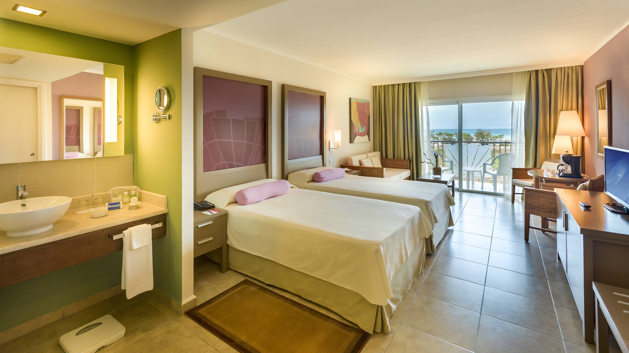 a room with two beds and a balcony