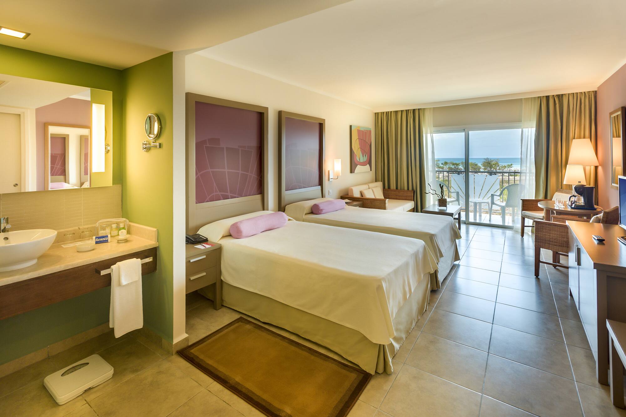 a room with two beds and a balcony