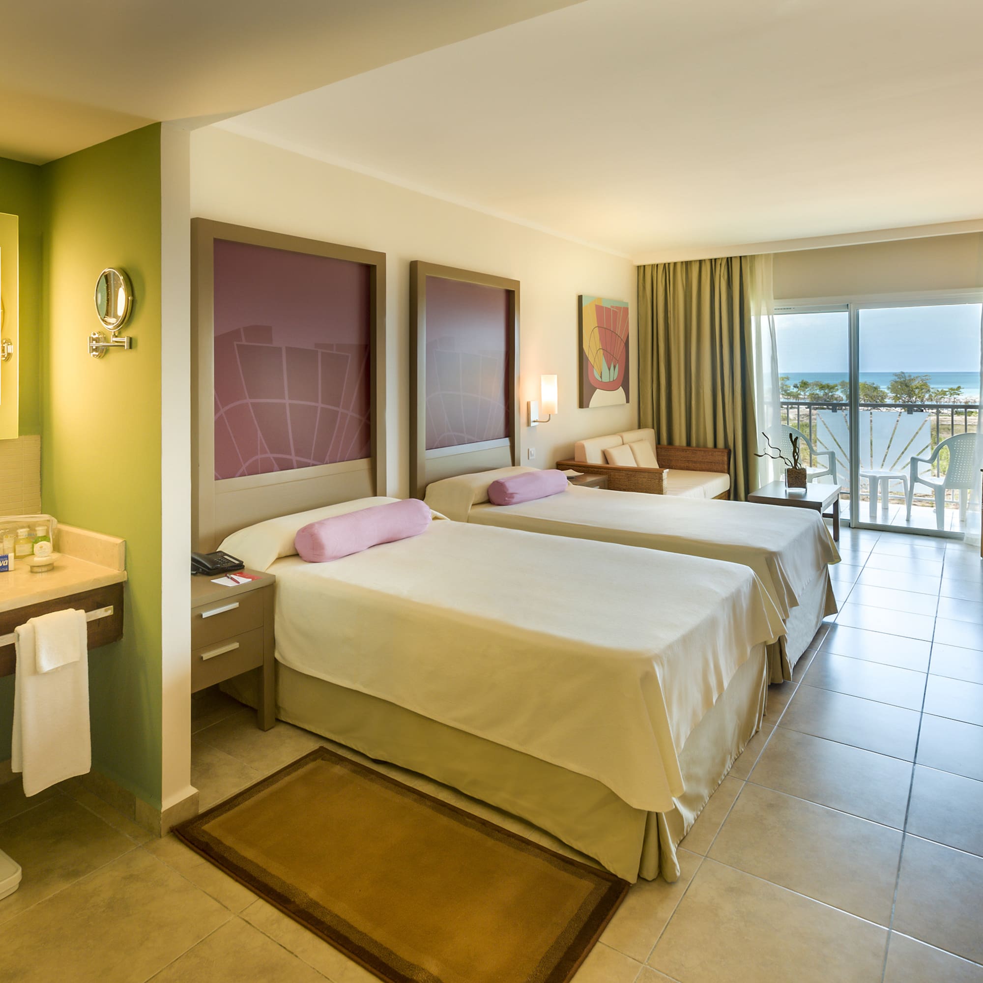 a room with two beds and a balcony