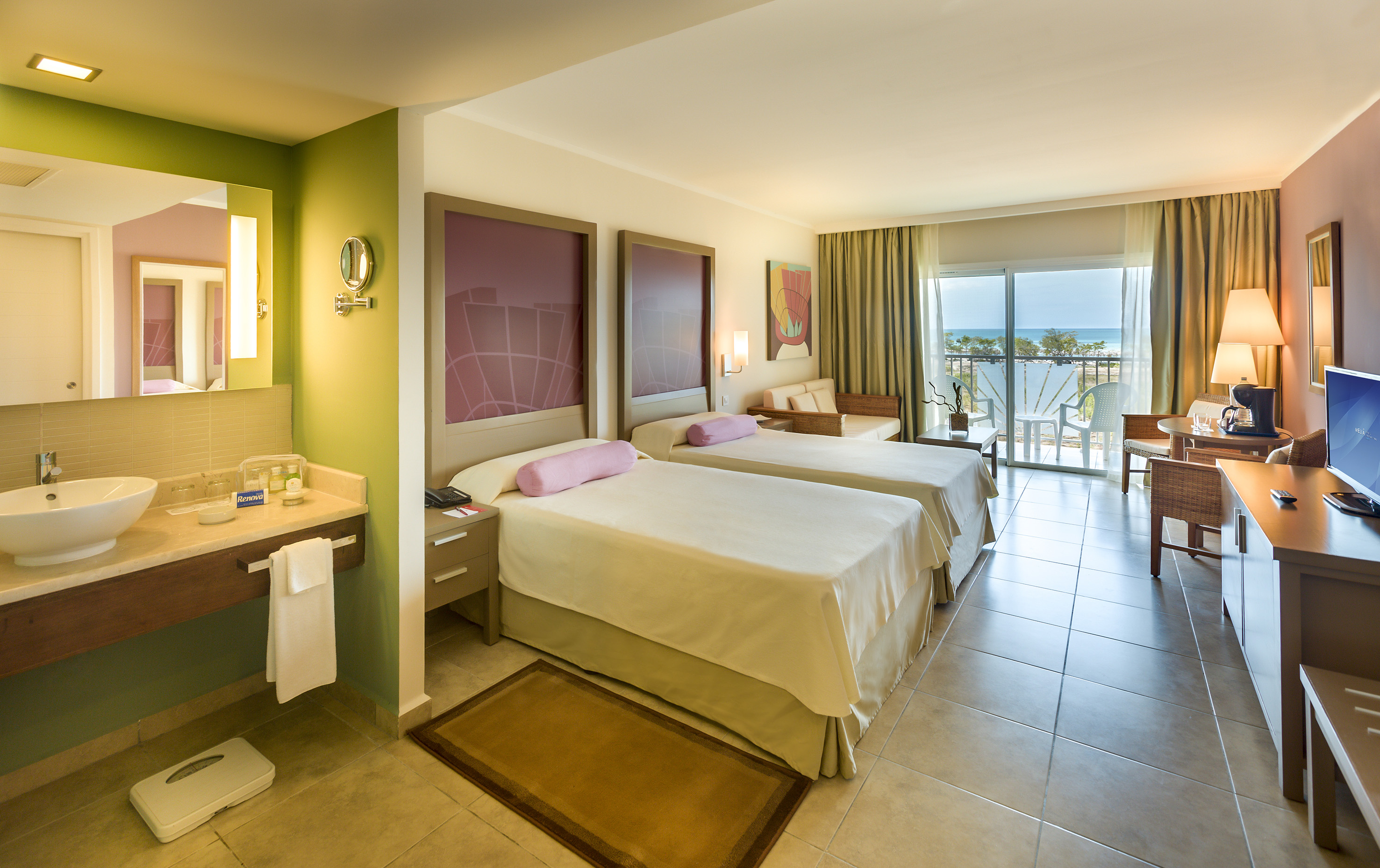 a room with two beds and a balcony