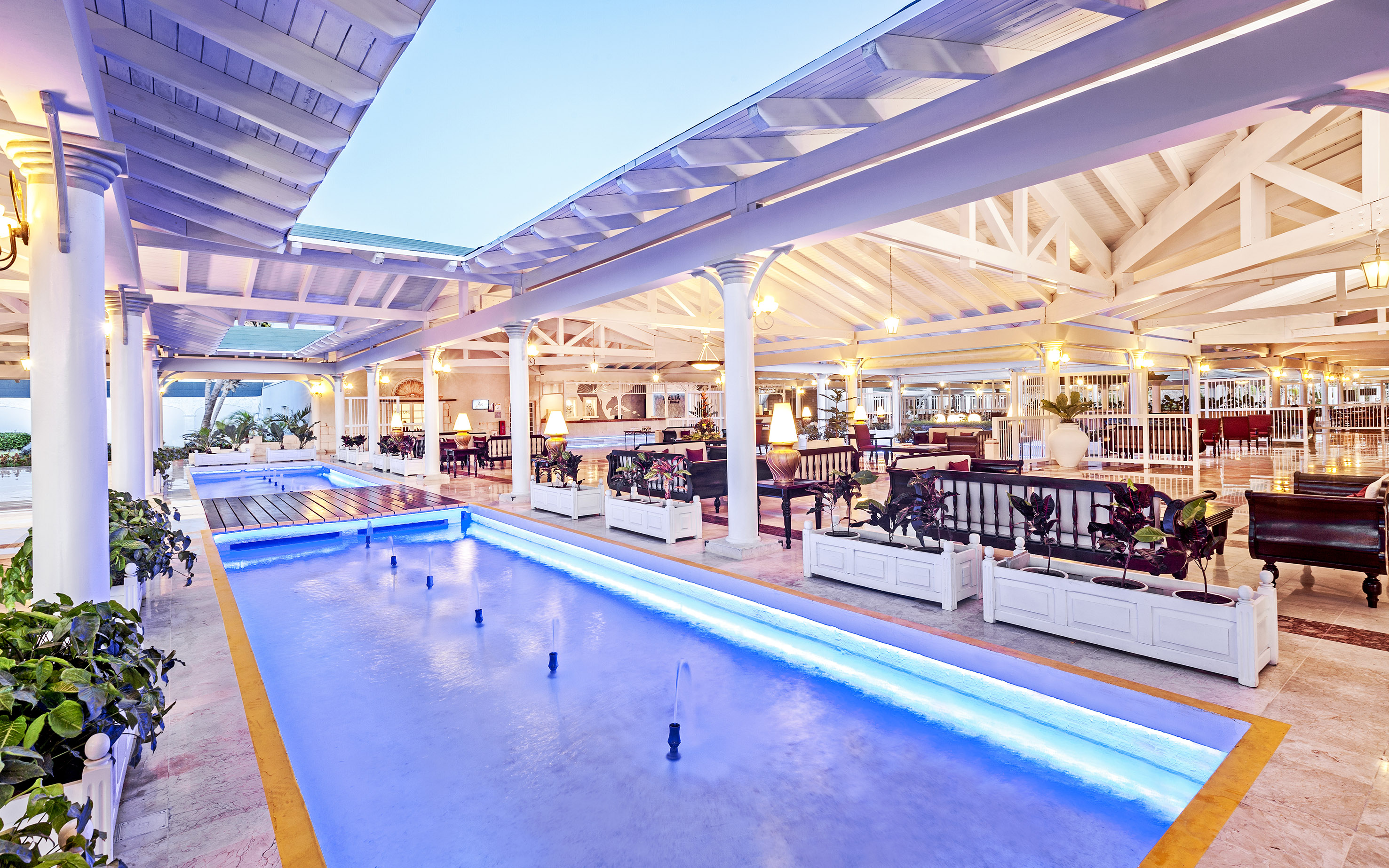 a pool with a fountain in a building