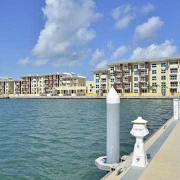 a dock with buildings next to the water