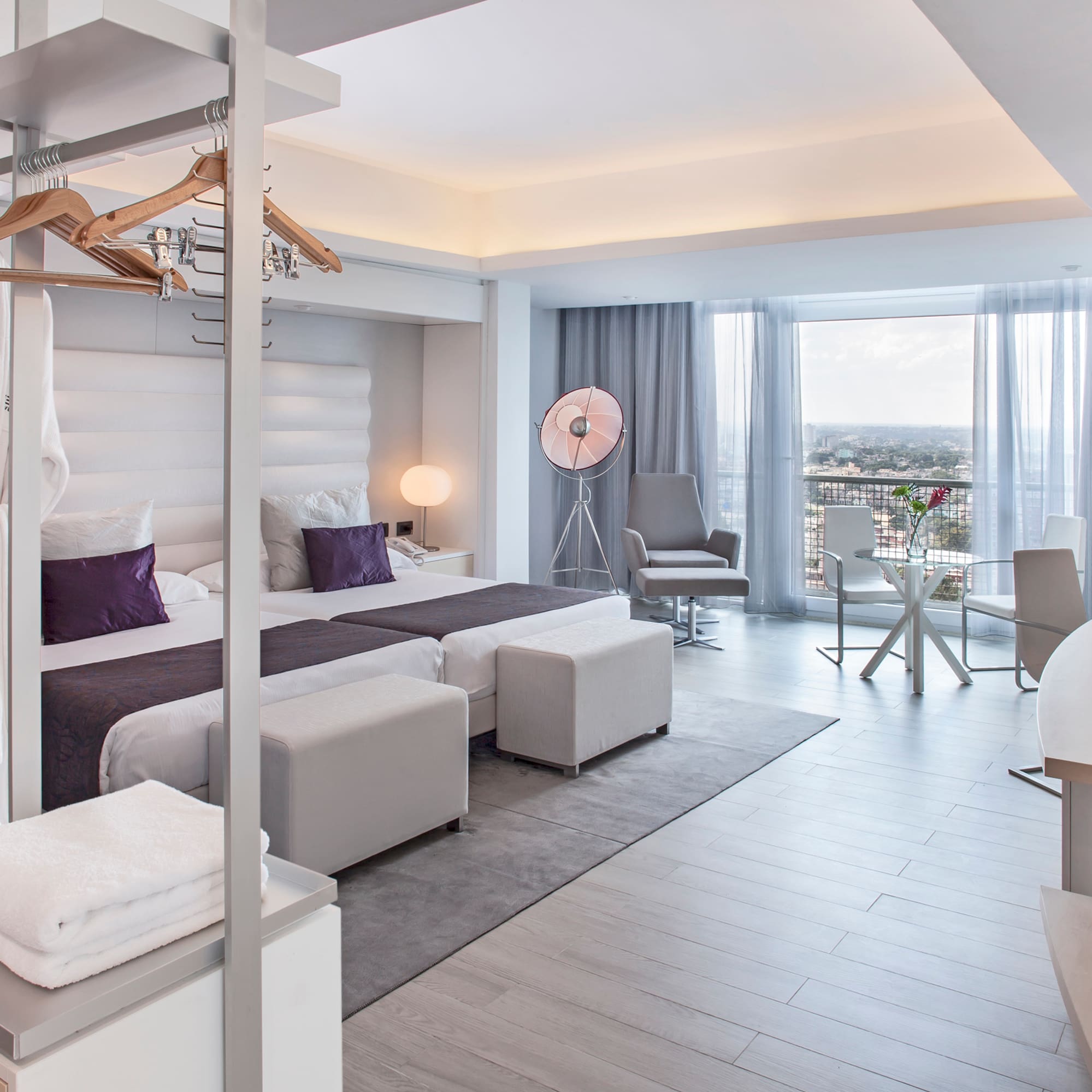 a room with a bed and a table and chairs
