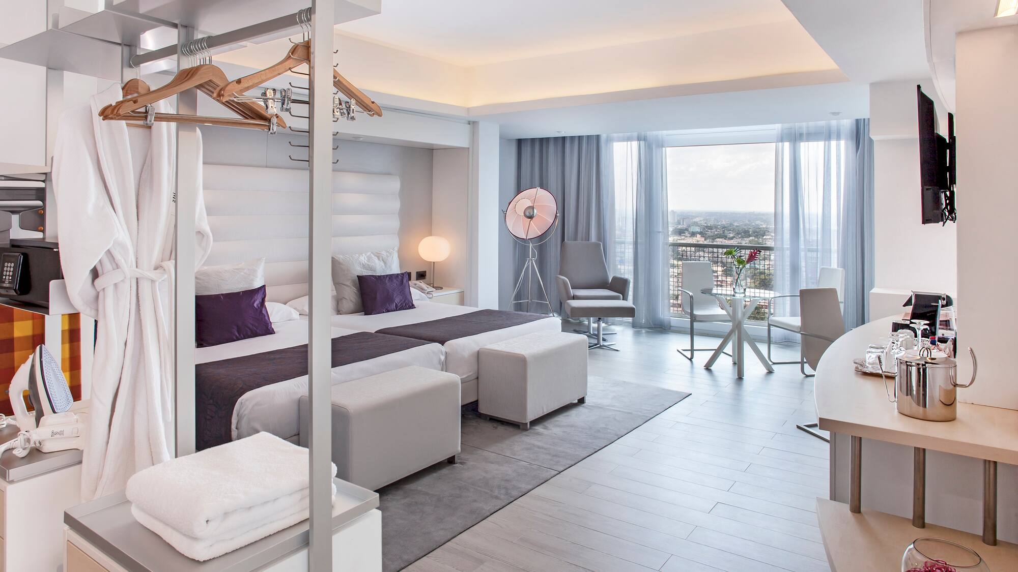 a room with a bed and a table and chairs