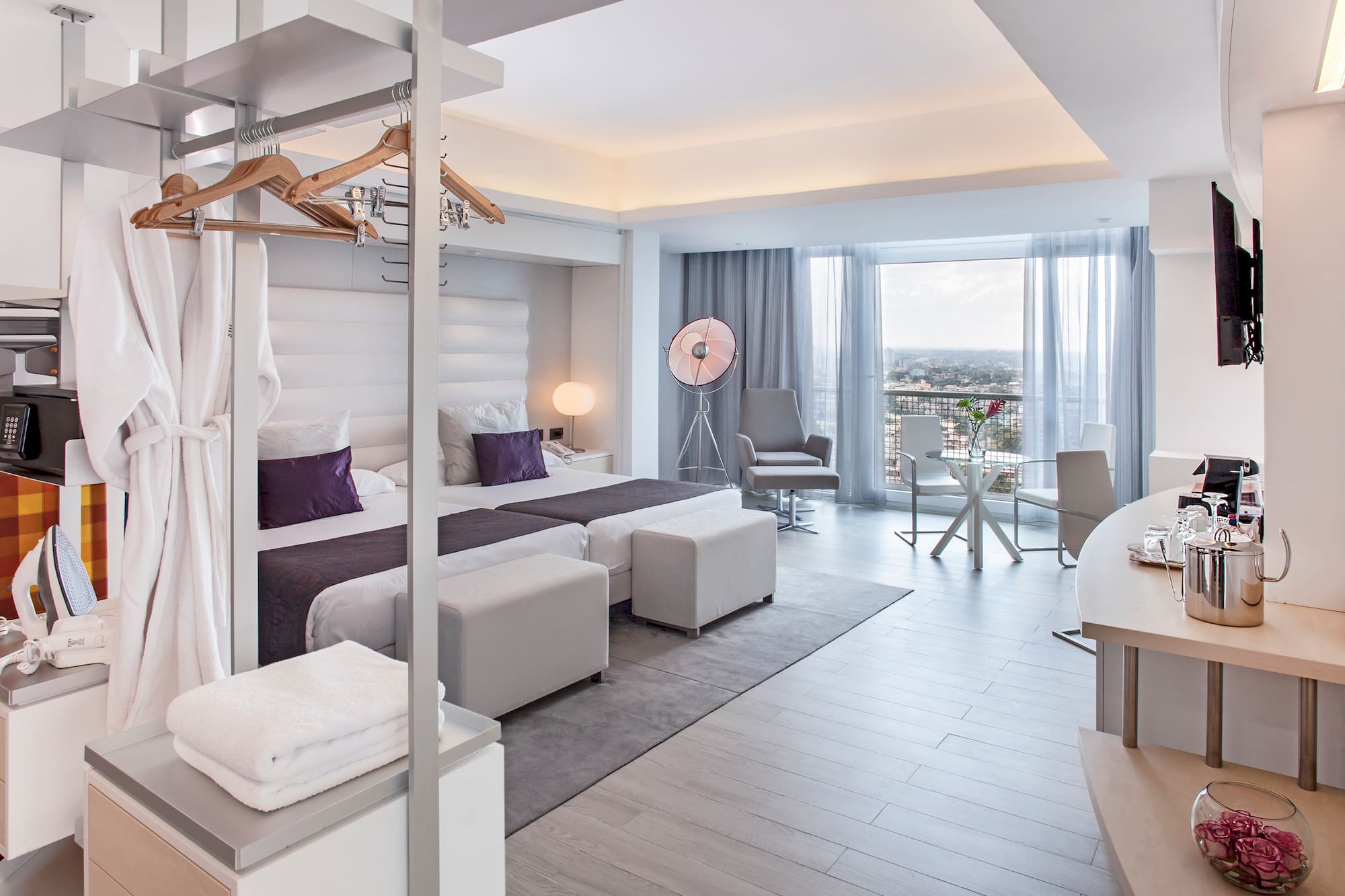 a room with a bed and a table and chairs