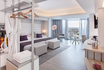 a room with a bed and a table and chairs