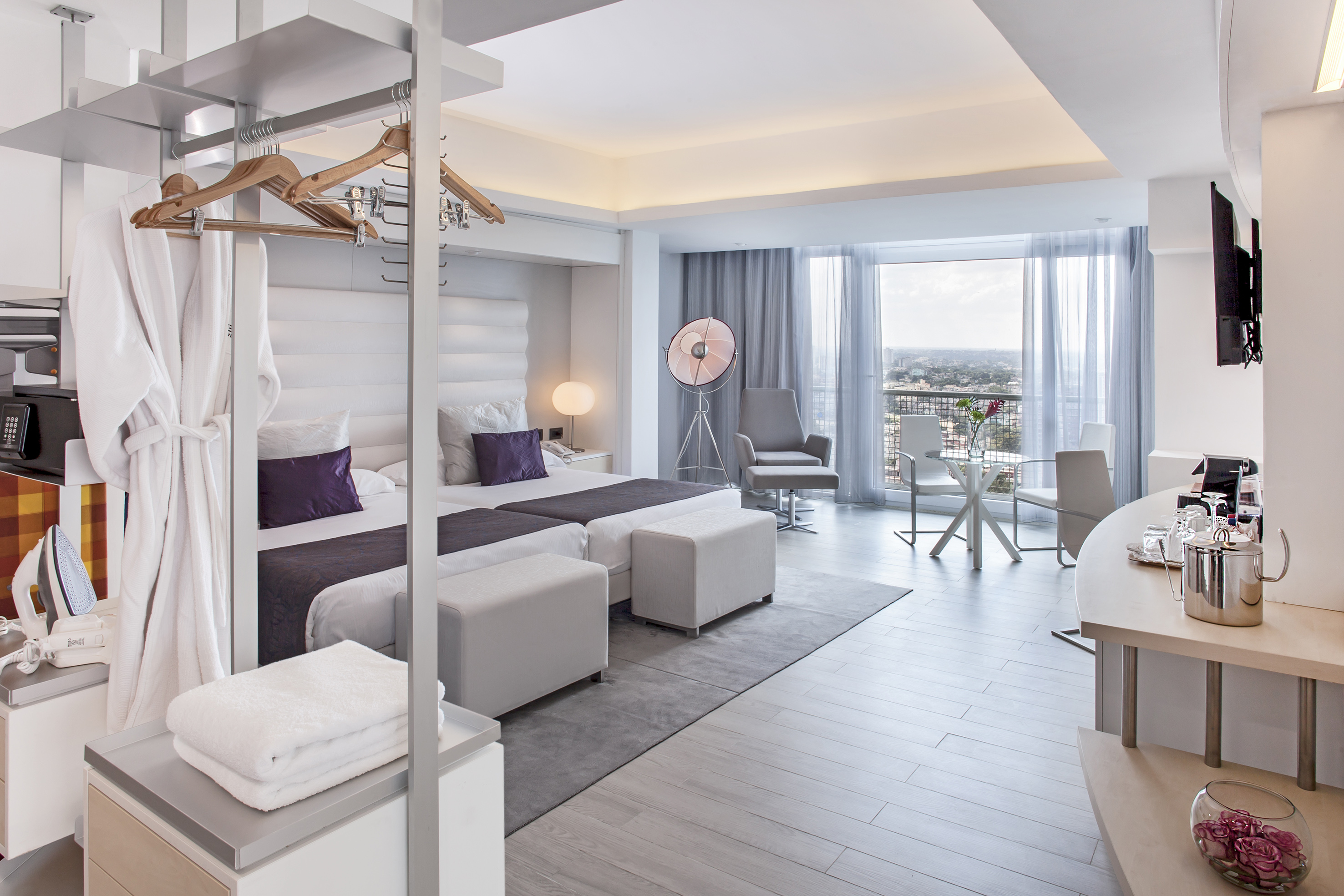 a room with a bed and a table and chairs