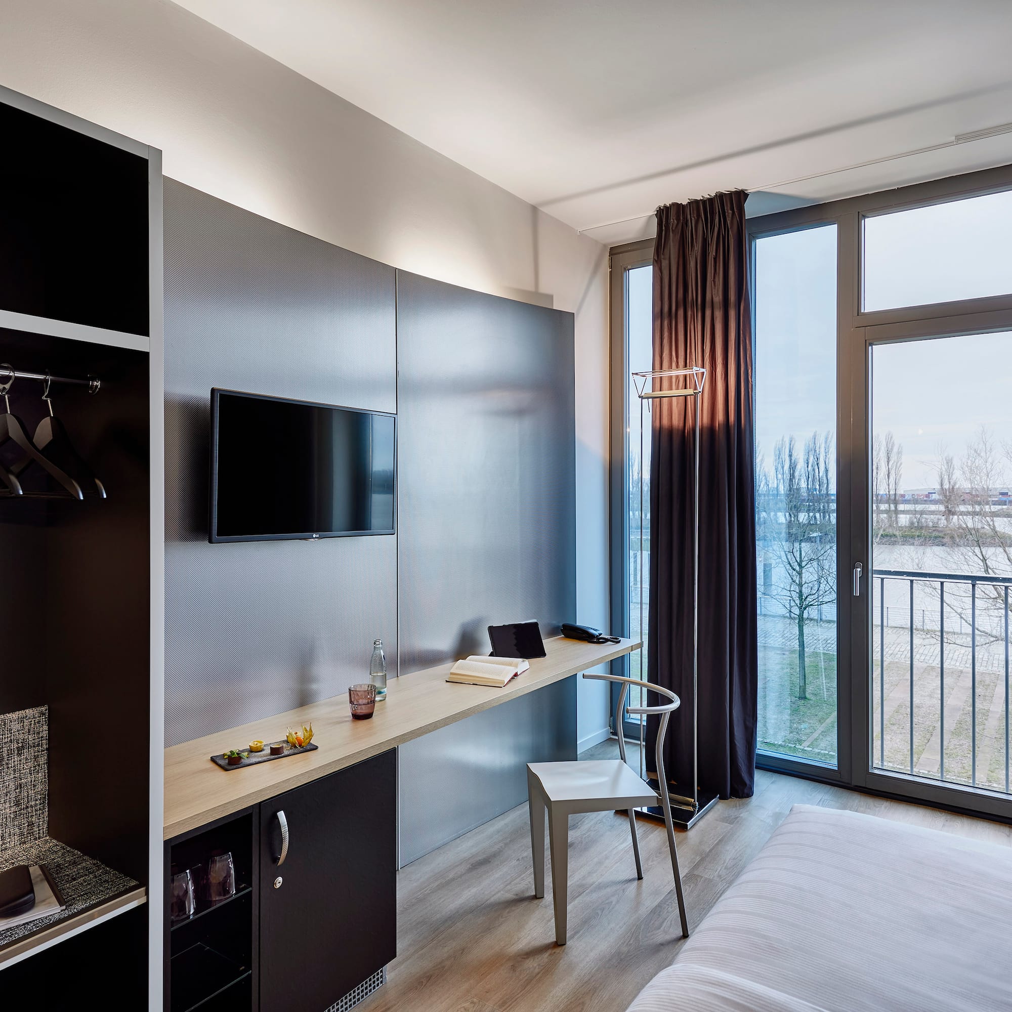 a room with a bed and a tv