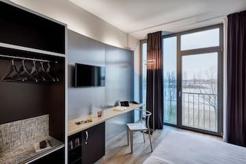 a room with a bed and a tv