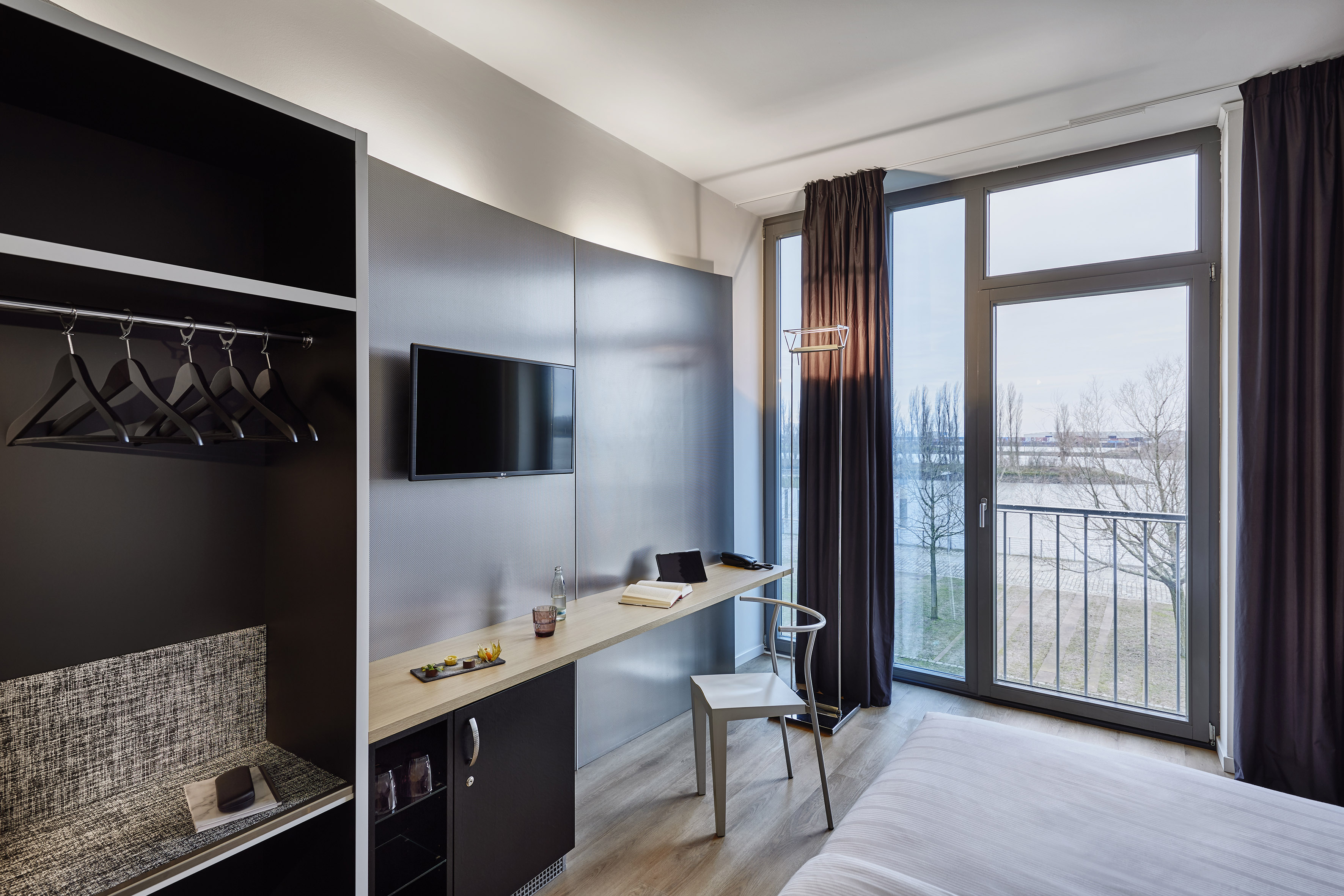 a room with a bed and a tv