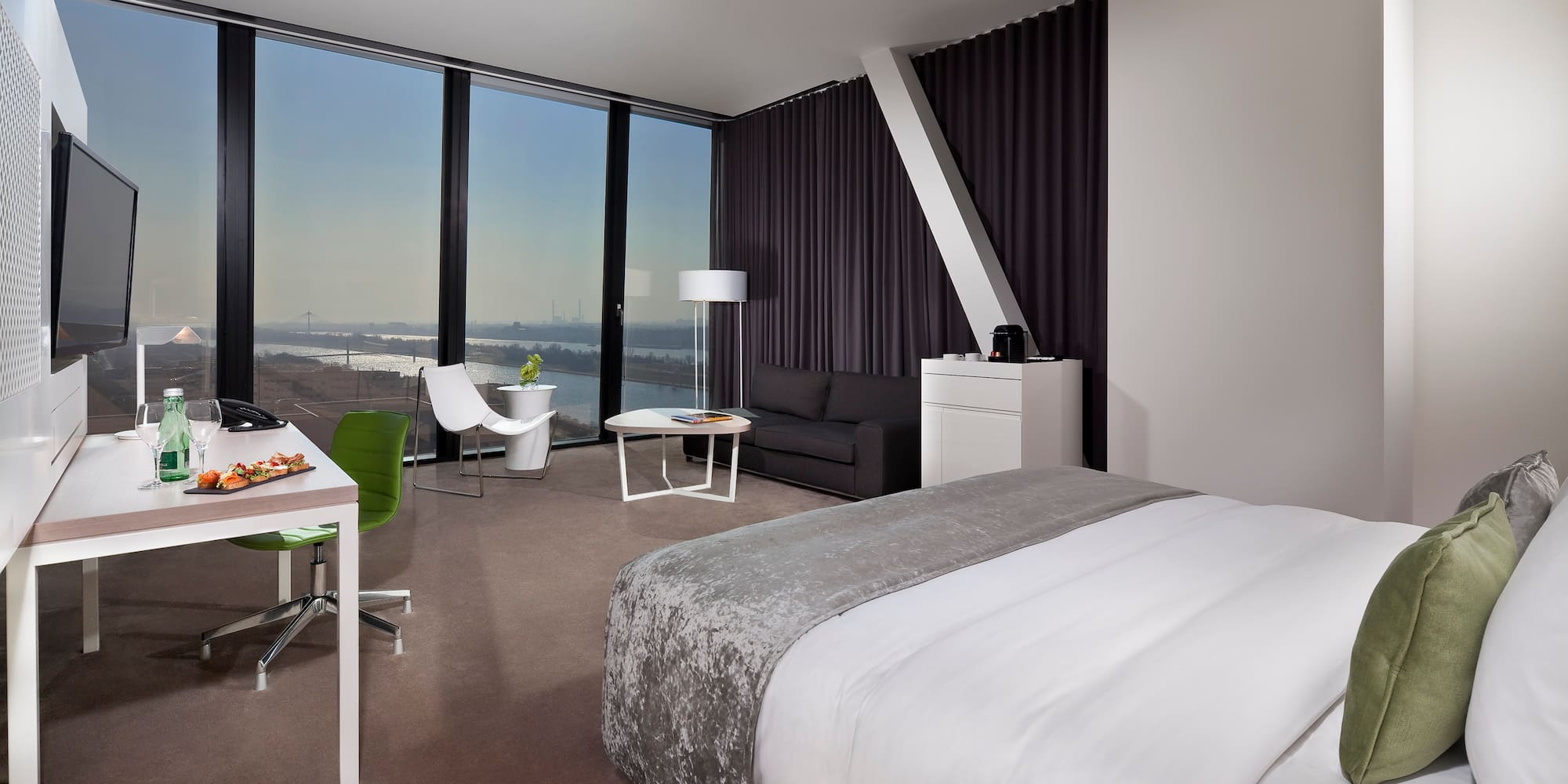 a room with a bed and a table and chairs