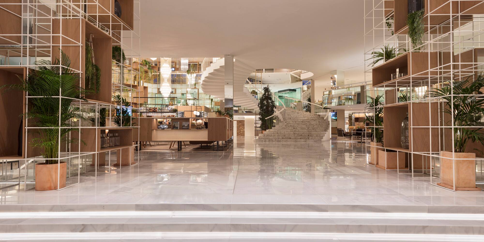 a large white staircase with shelves and shelves