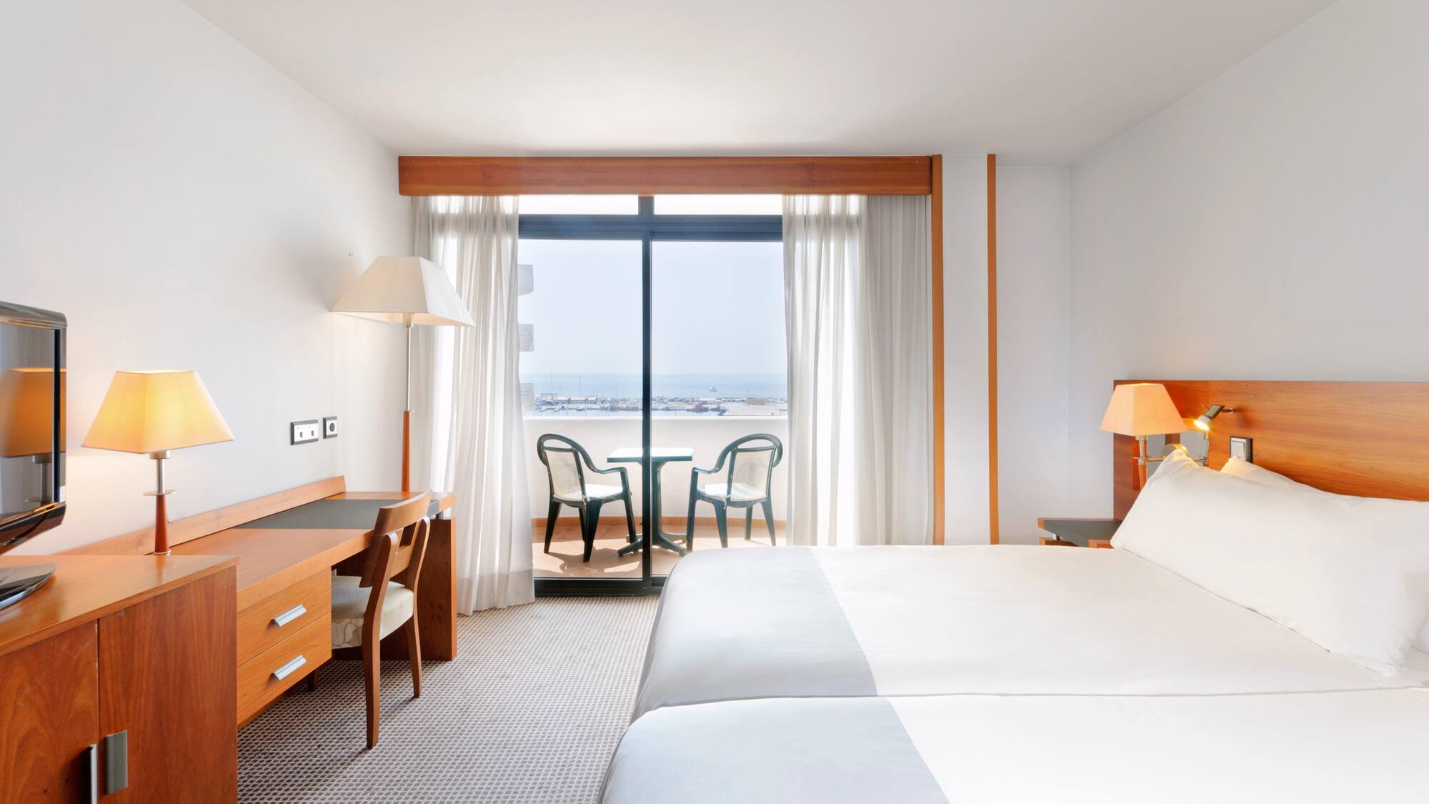 a room with a bed and a table and chairs