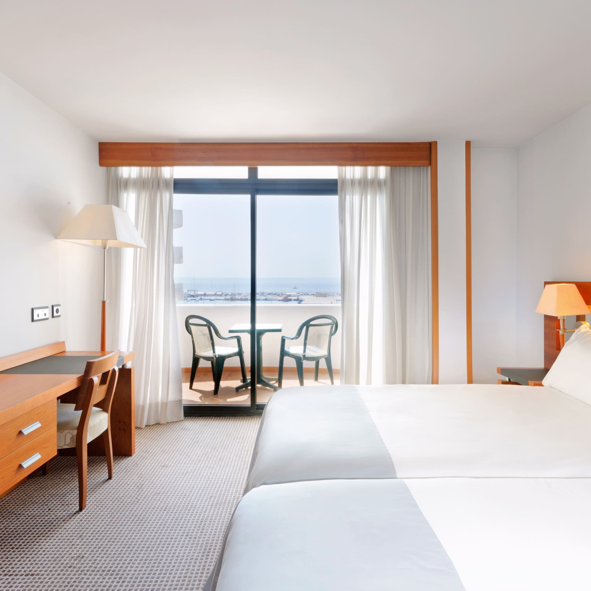 a room with a bed and a table and chairs