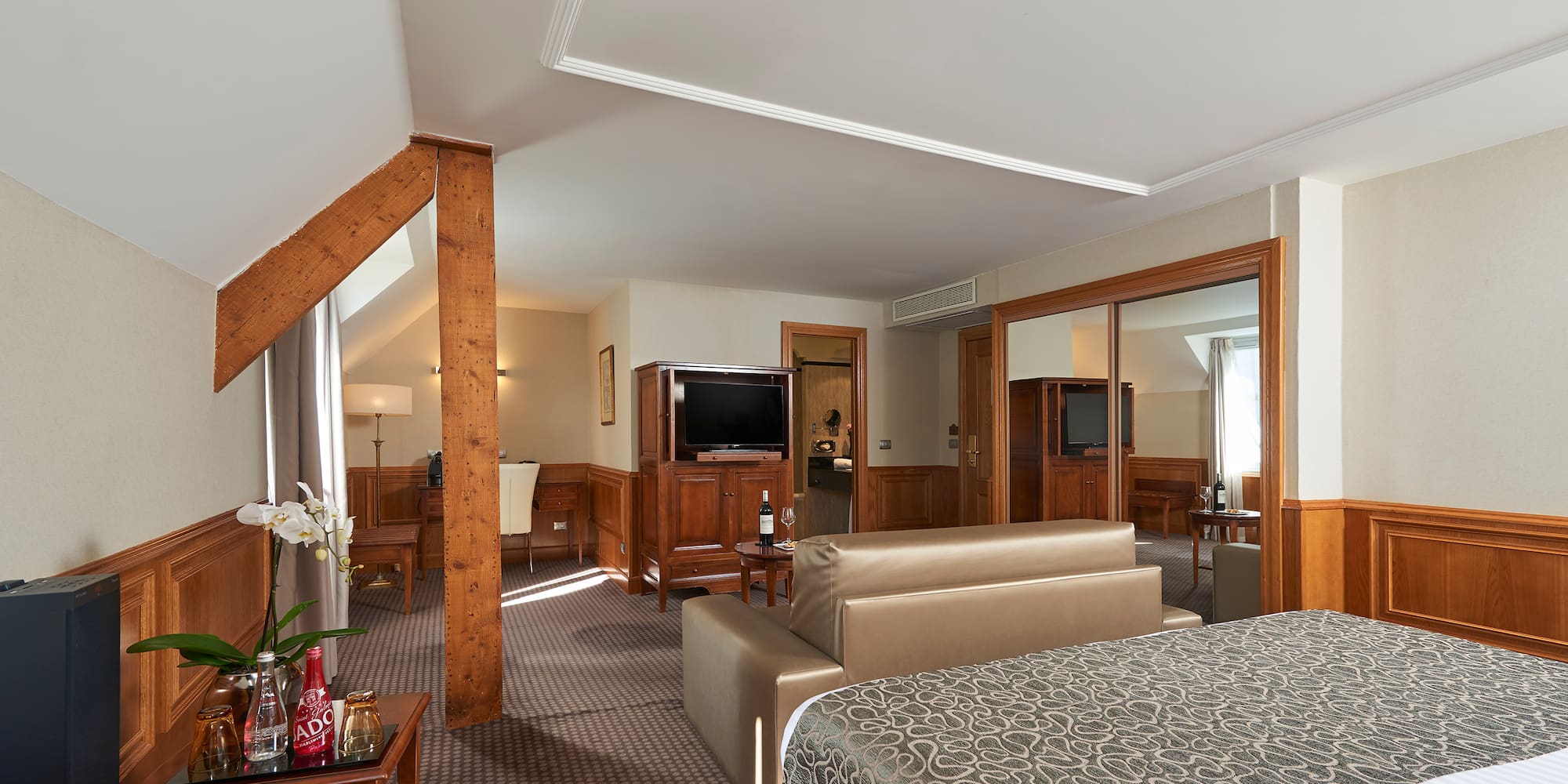 a bedroom with a bed and a television