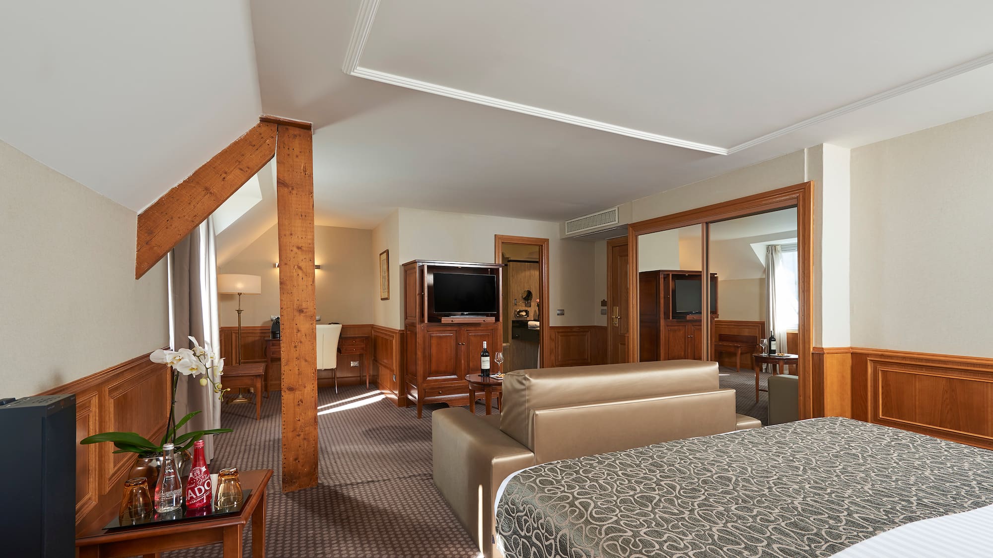 a bedroom with a bed and a television