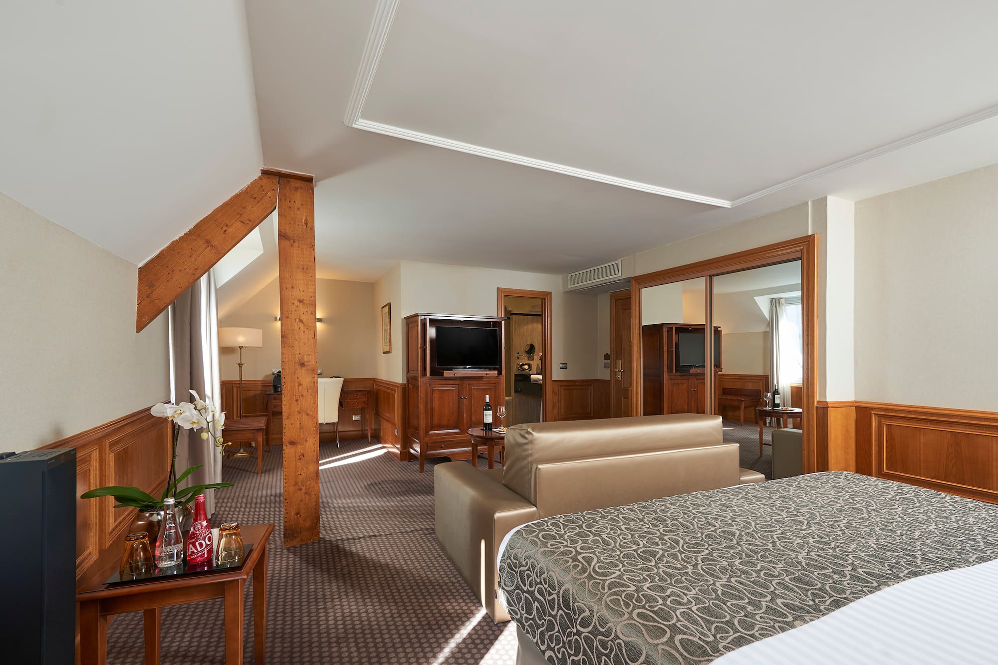 a bedroom with a bed and a television