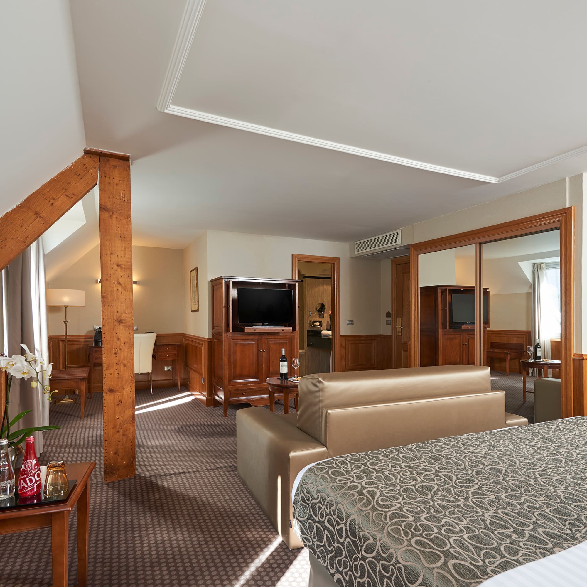 a bedroom with a bed and a television