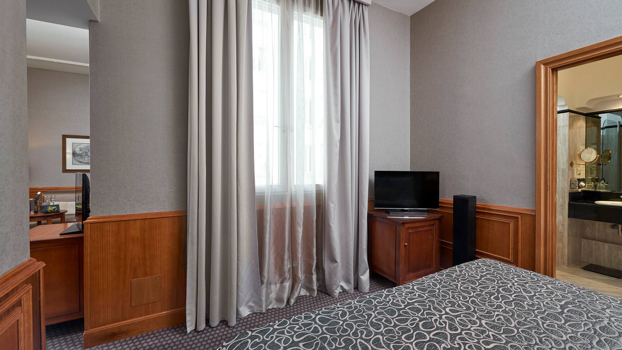 a room with a bed and a tv