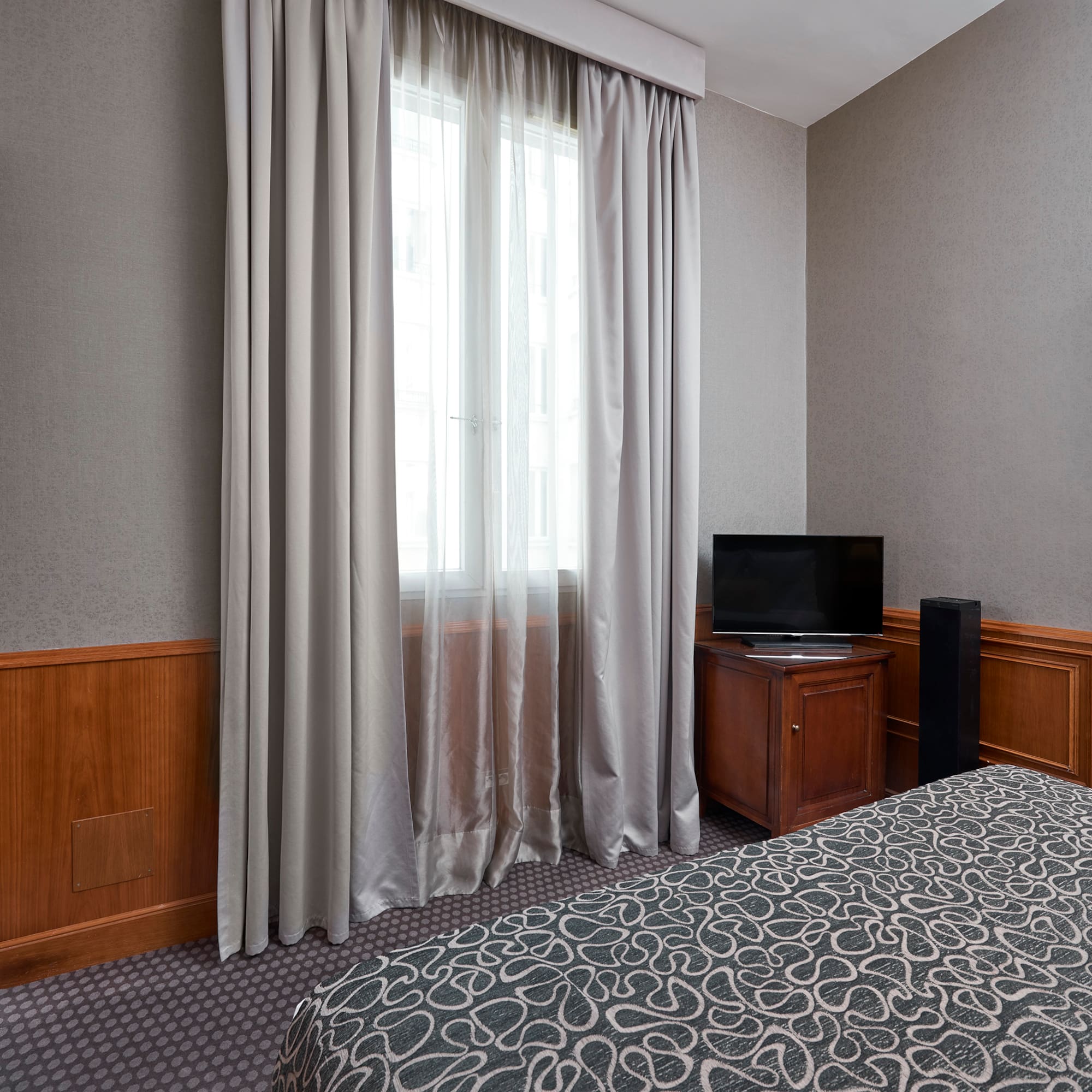 a room with a bed and a tv