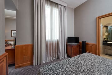 a room with a bed and a tv