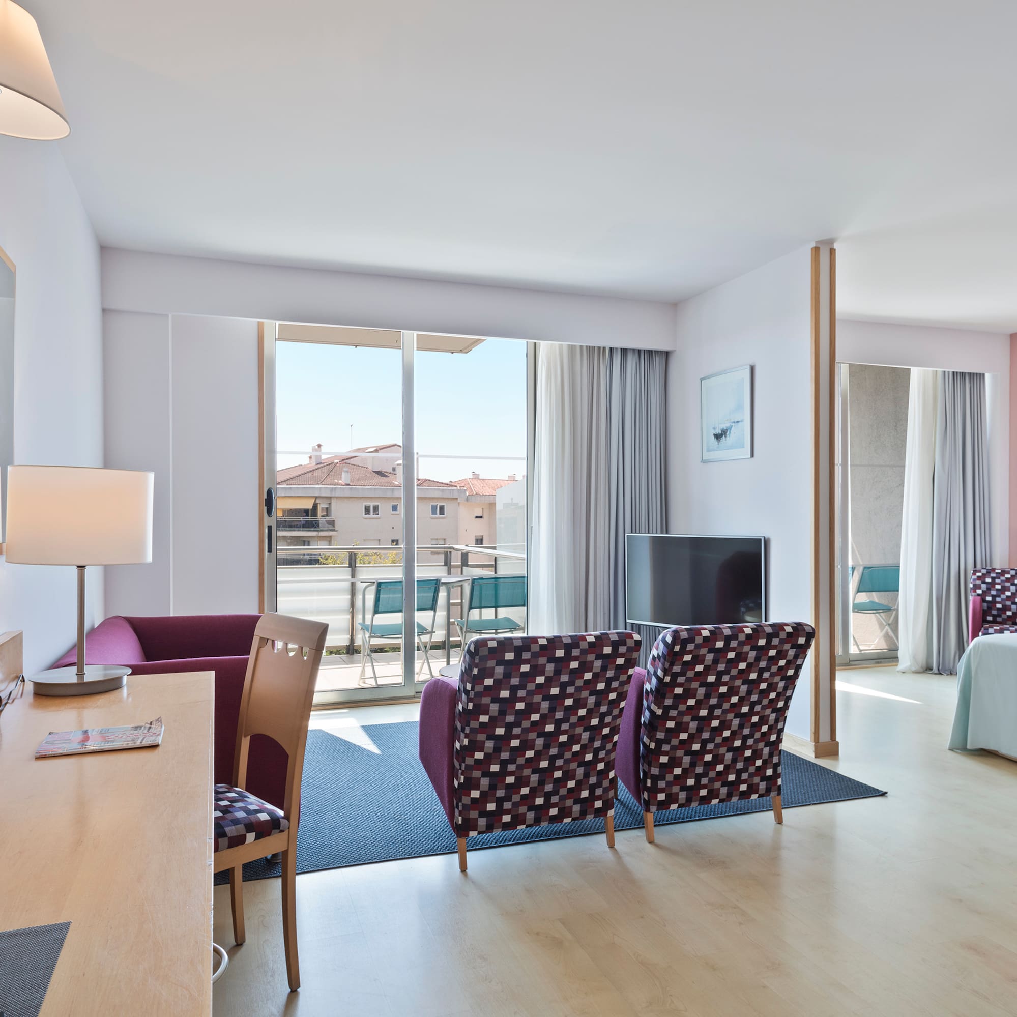 a room with a bed and a television