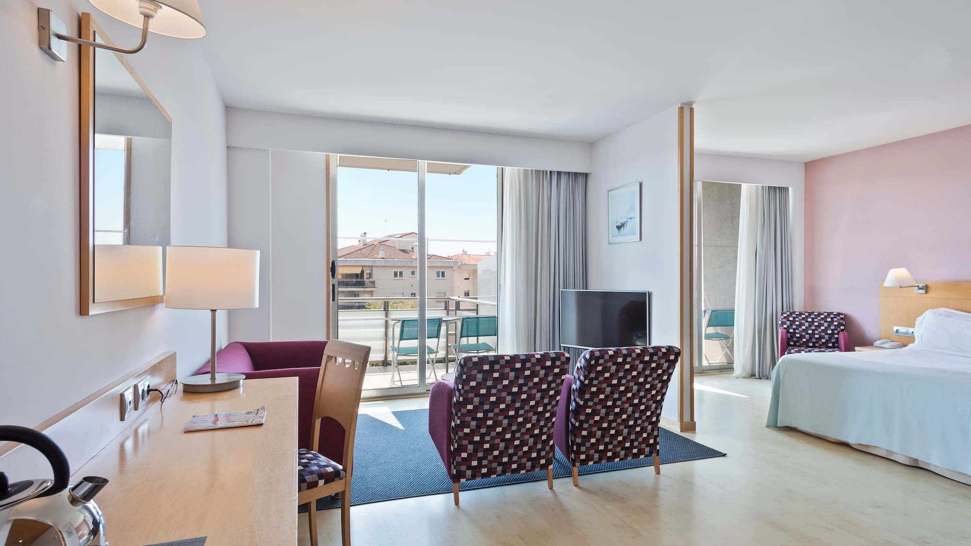 a room with a bed and a television