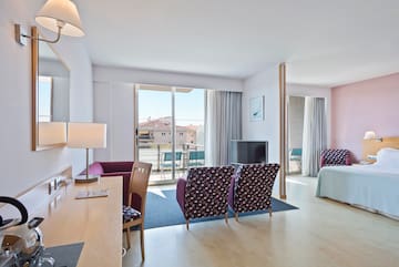 a room with a bed and a television