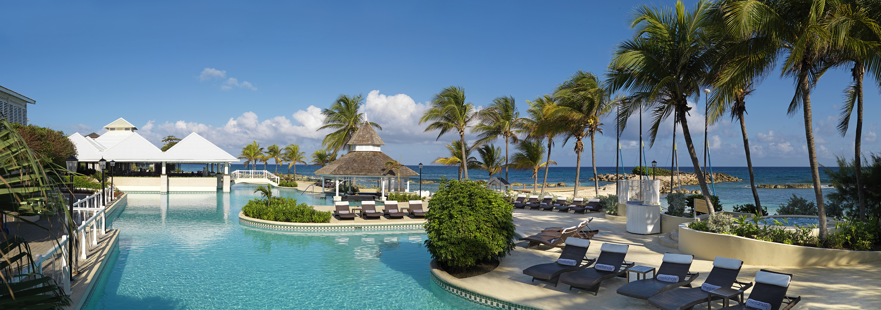 a pool with lounge chairs and palm trees