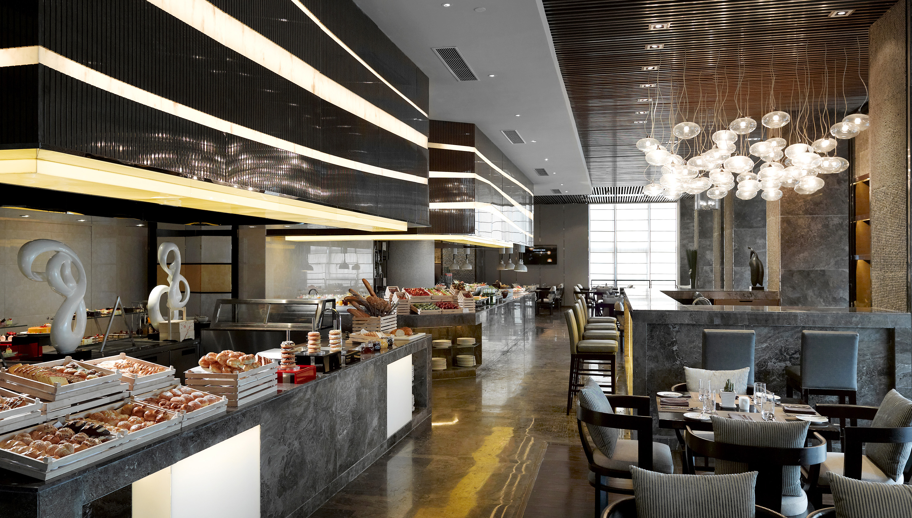 Modern luxury restaurant buffet with diverse food selections and stylish interior.