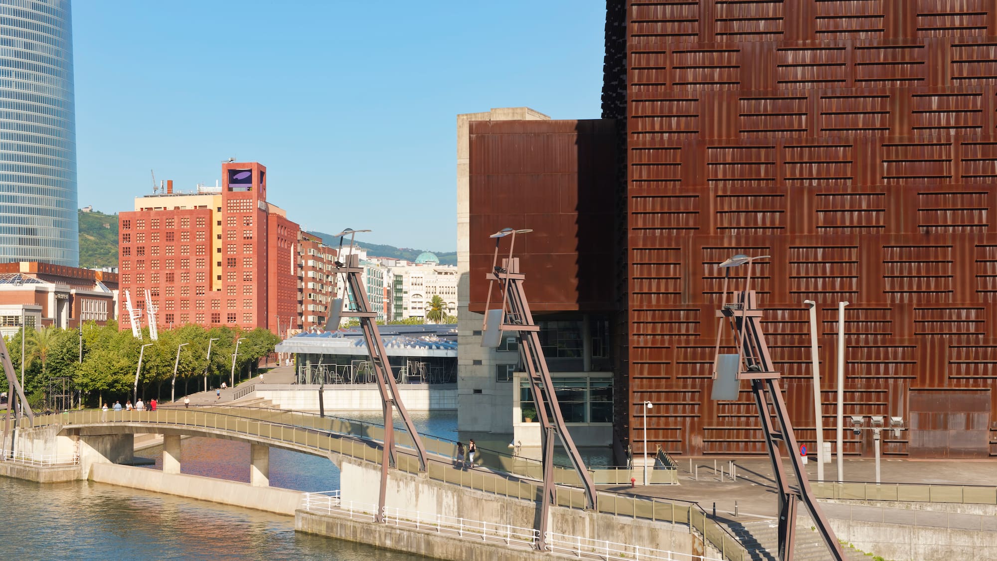 a bridge over a river with a building in the background