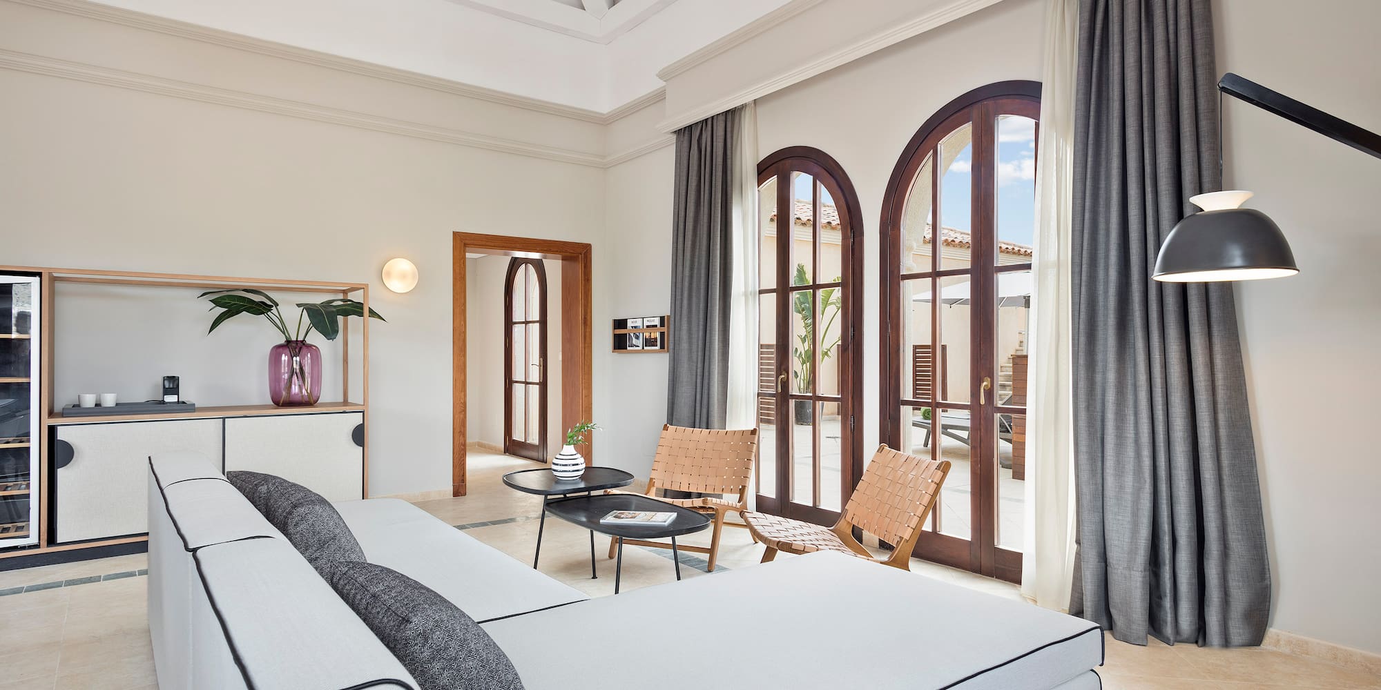 a room with a large bed and chairs