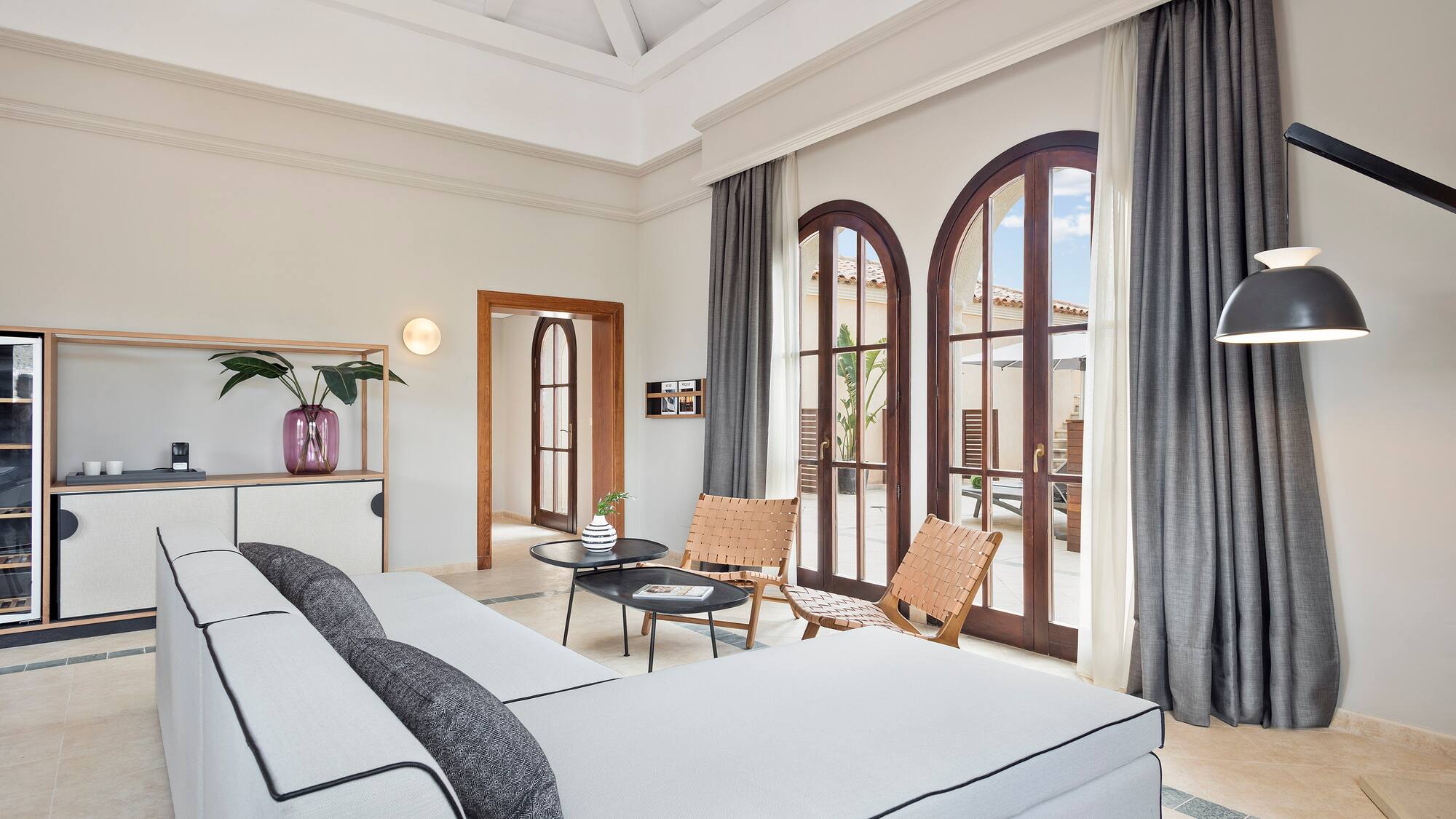 a room with a large bed and chairs