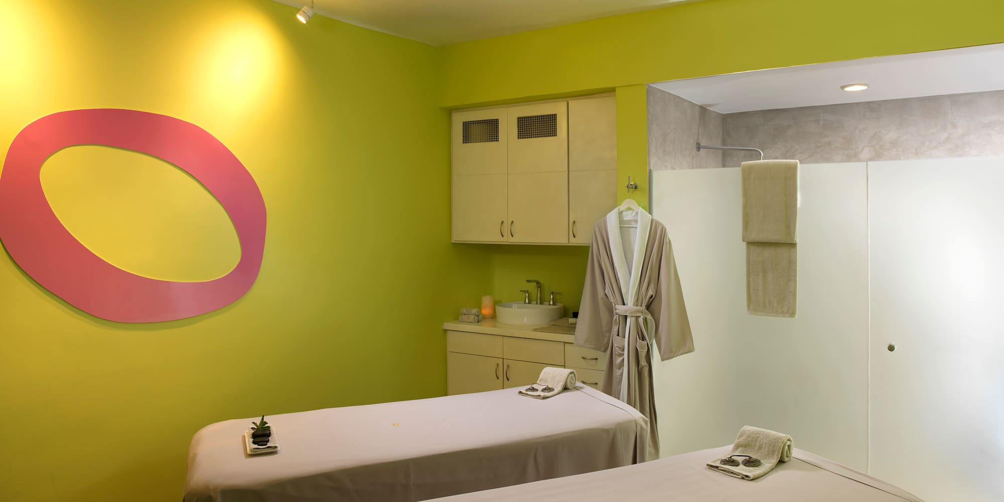 a room with massage beds and towels